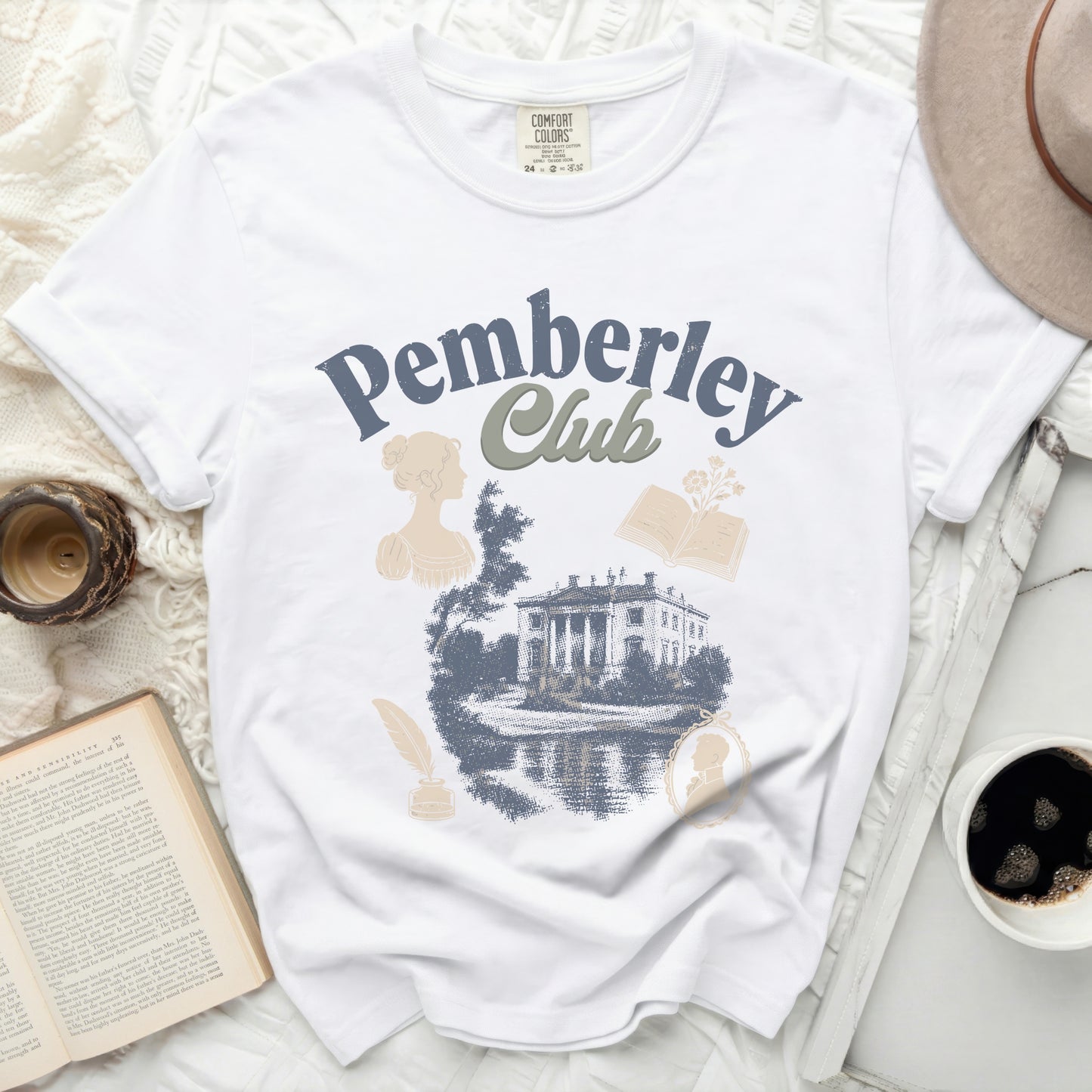 White t-shirt with "Pemberley Club" graphic featuring a manor and vintage silhouettes.