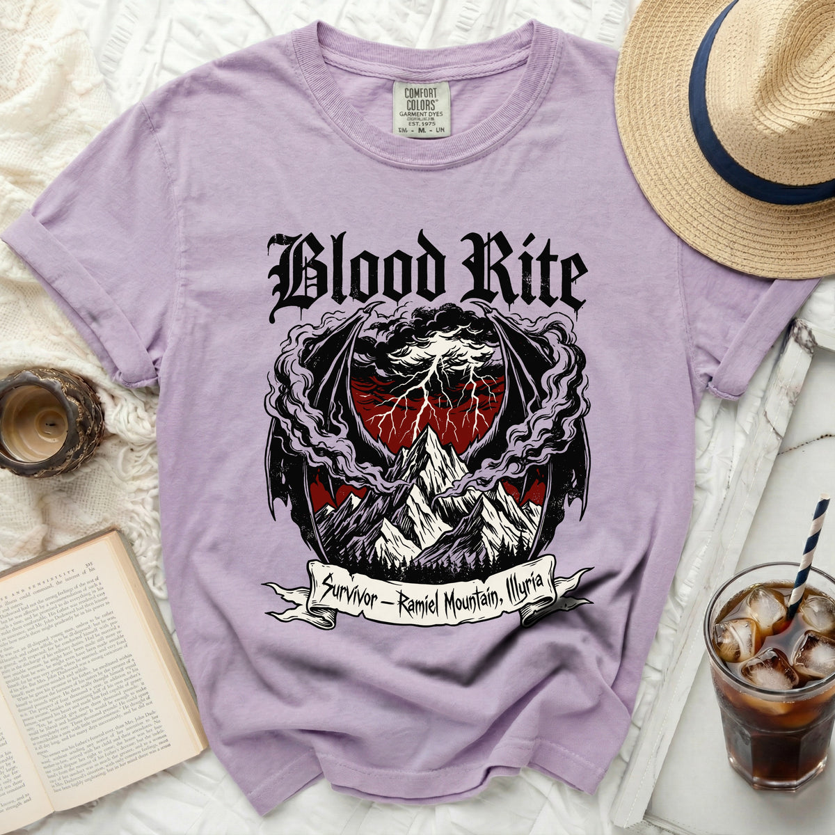 Lavender t-shirt with "Blood Rite" and mountain graphic.