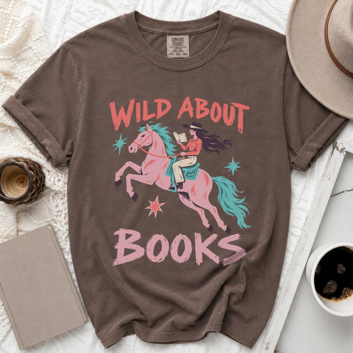 Brown t-shirt with a pink horse, cowgirl reading, and "Wild About Books" text.