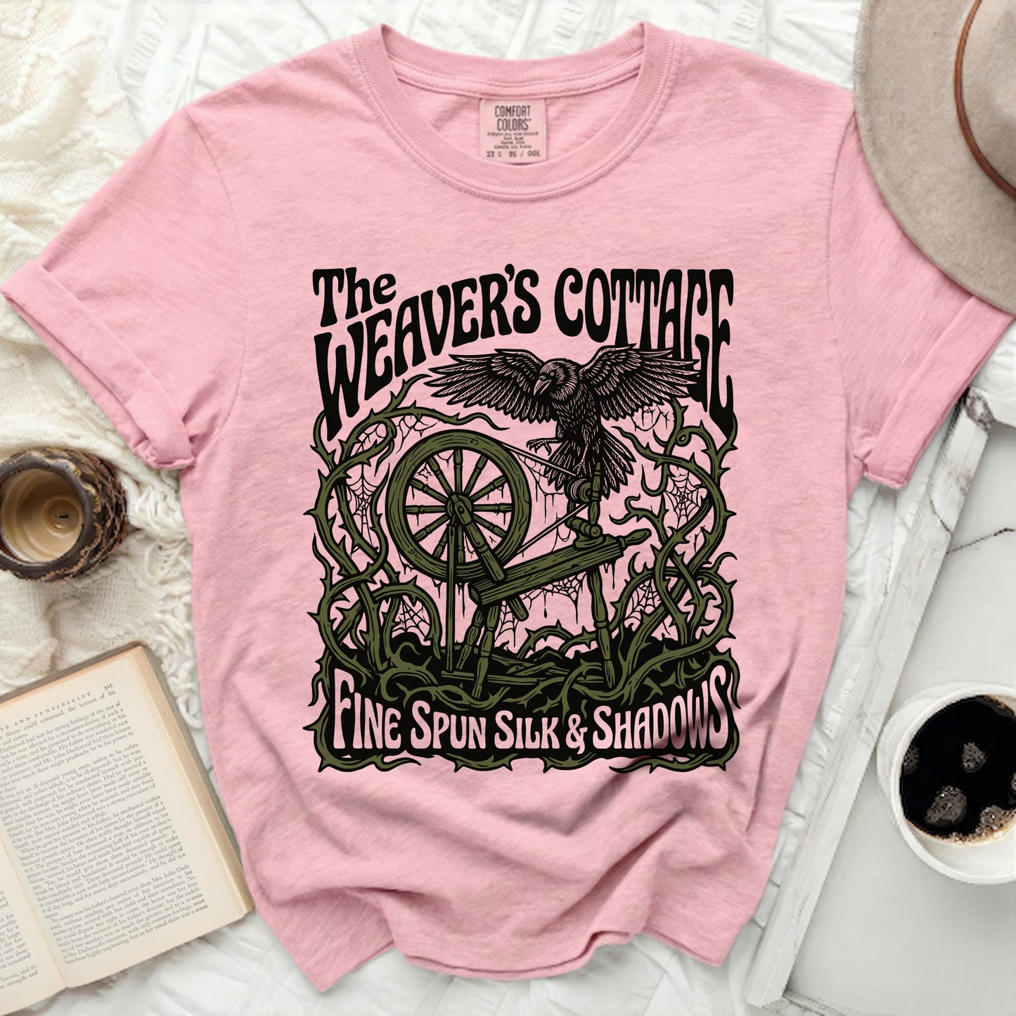 Pink t-shirt with "The Weaver's Cottage Fine Spun Silk & Shadows" graphic.