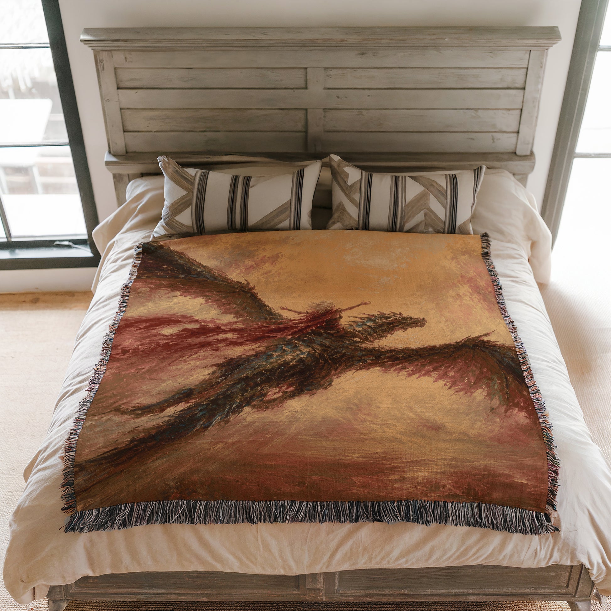 a bedroom with a bed covered in a large, colorful blanket featuring an artistic design. The blanket is spread over the bed, creating a visually striking and inviting scene.