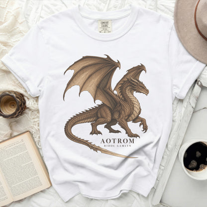 White t-shirt with a brown dragon graphic and text "AOTROM RIDOC GAMLYN".