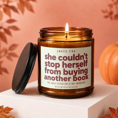 Amber jar candle lit, reading "smells like she couldn't stop herself from buying another book."