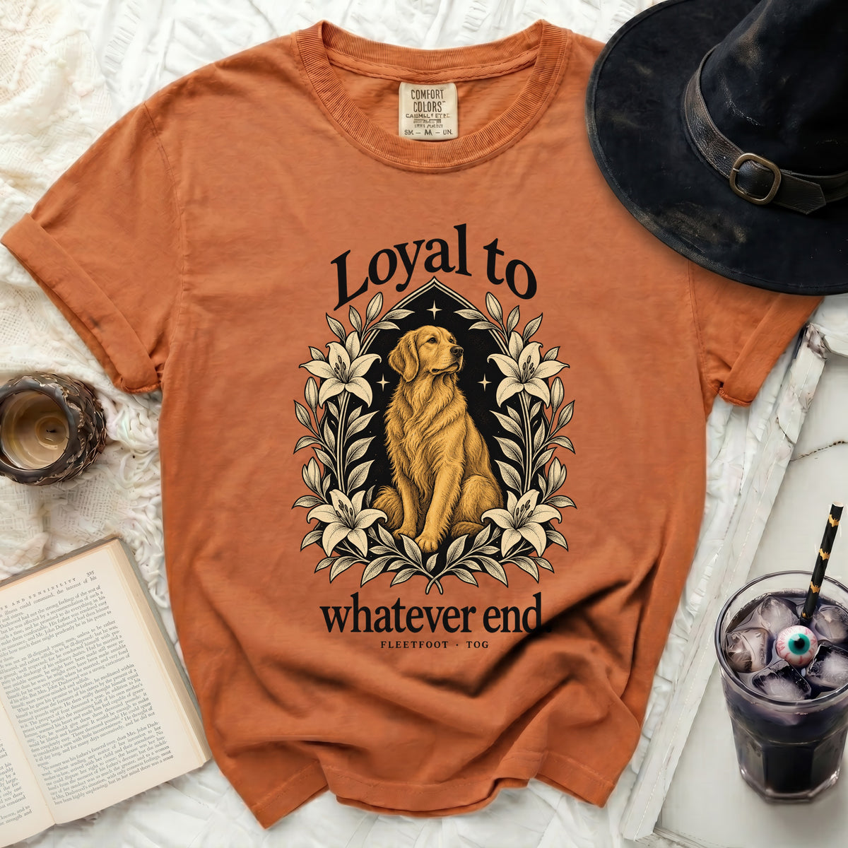 Golden retriever graphic with text "Loyal to whatever end" on orange shirt.