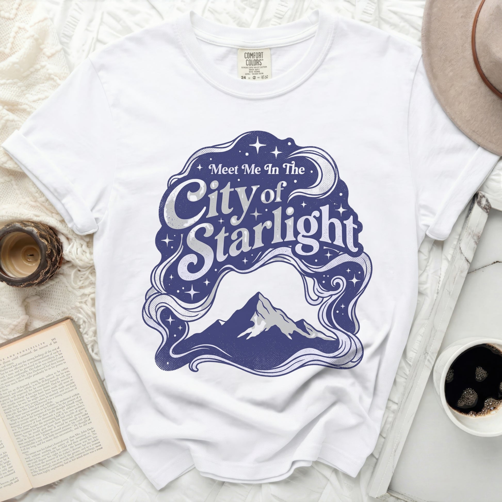 White t-shirt with "Meet Me In The City of Starlight" graphic.