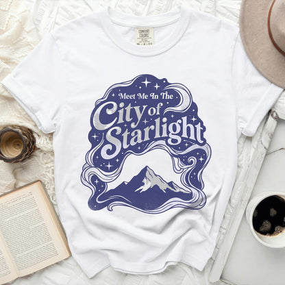 White t-shirt with "Meet Me In The City of Starlight" graphic.
