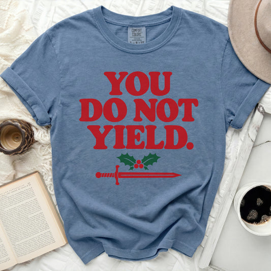 Blue t-shirt with red text "YOU DO NOT YIELD." and sword with holly.