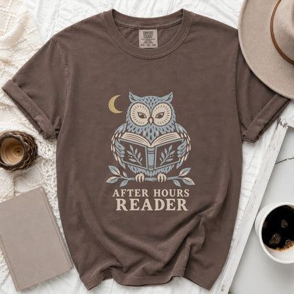 Brown t-shirt with a graphic of an owl reading a book under a moon.