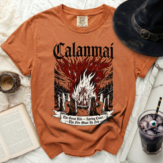 Orange t-shirt with bonfire, stones, and text "Calanmai The Great Rite - Spring Court The Fire Must Be Fed".