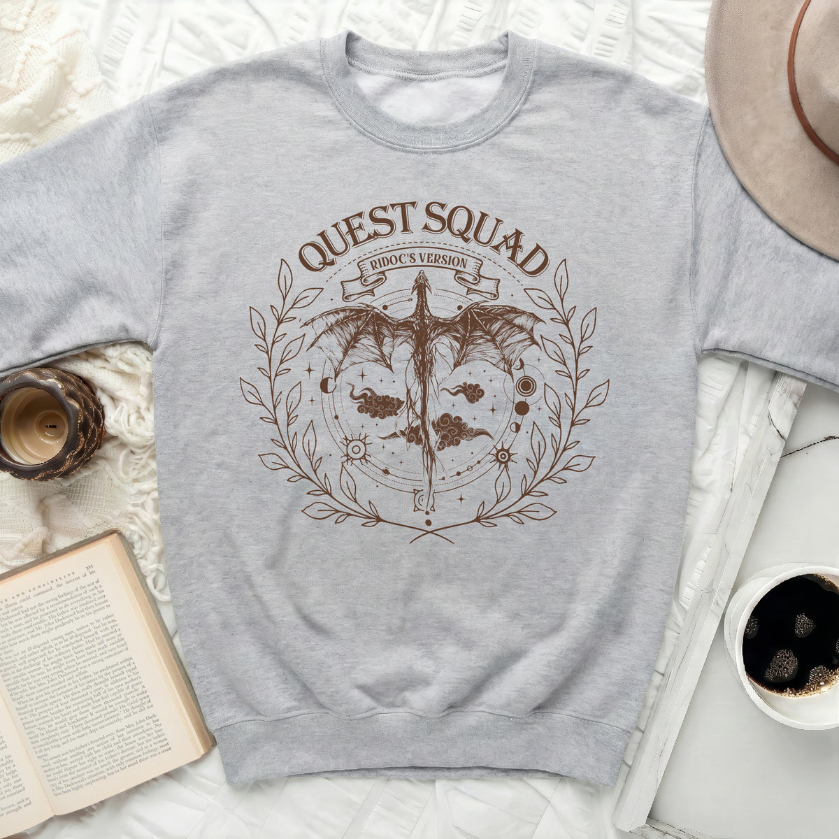 Light gray crewneck sweatshirt with a brown dragon graphic and "QUEST SQUAD RIDOC'S VERSION" text.