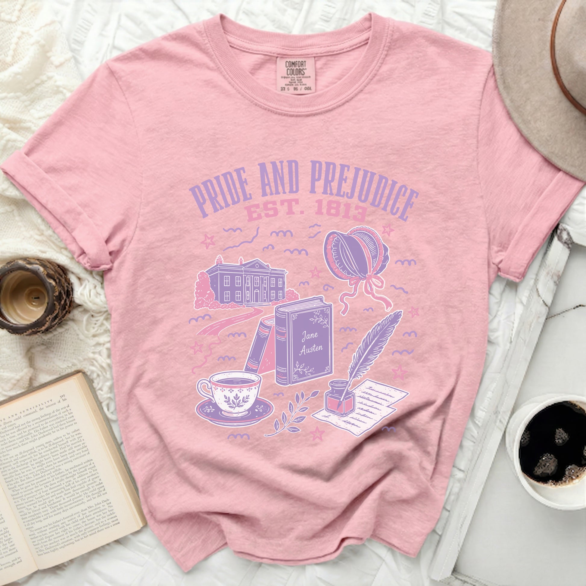 Pink t-shirt with Pride and Prejudice book icons and text.