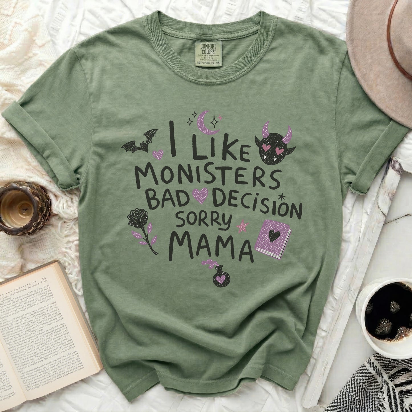 Green t-shirt with "I like monsters, bad decision, sorry mama" text and graphics.