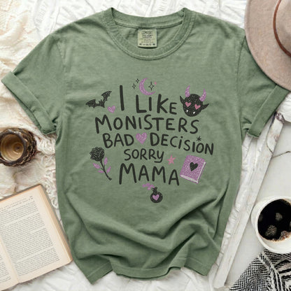 Green t-shirt with "I like monsters, bad decision, sorry mama" text and graphics.