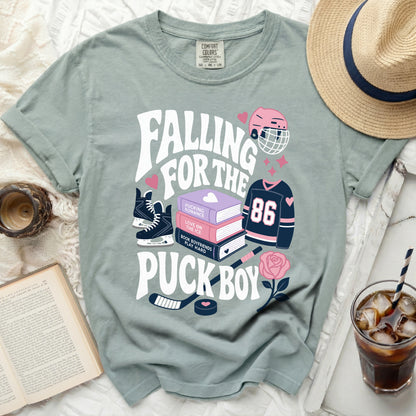 T-shirt with "Falling for the Pucking Puck Boy" and hockey graphics.