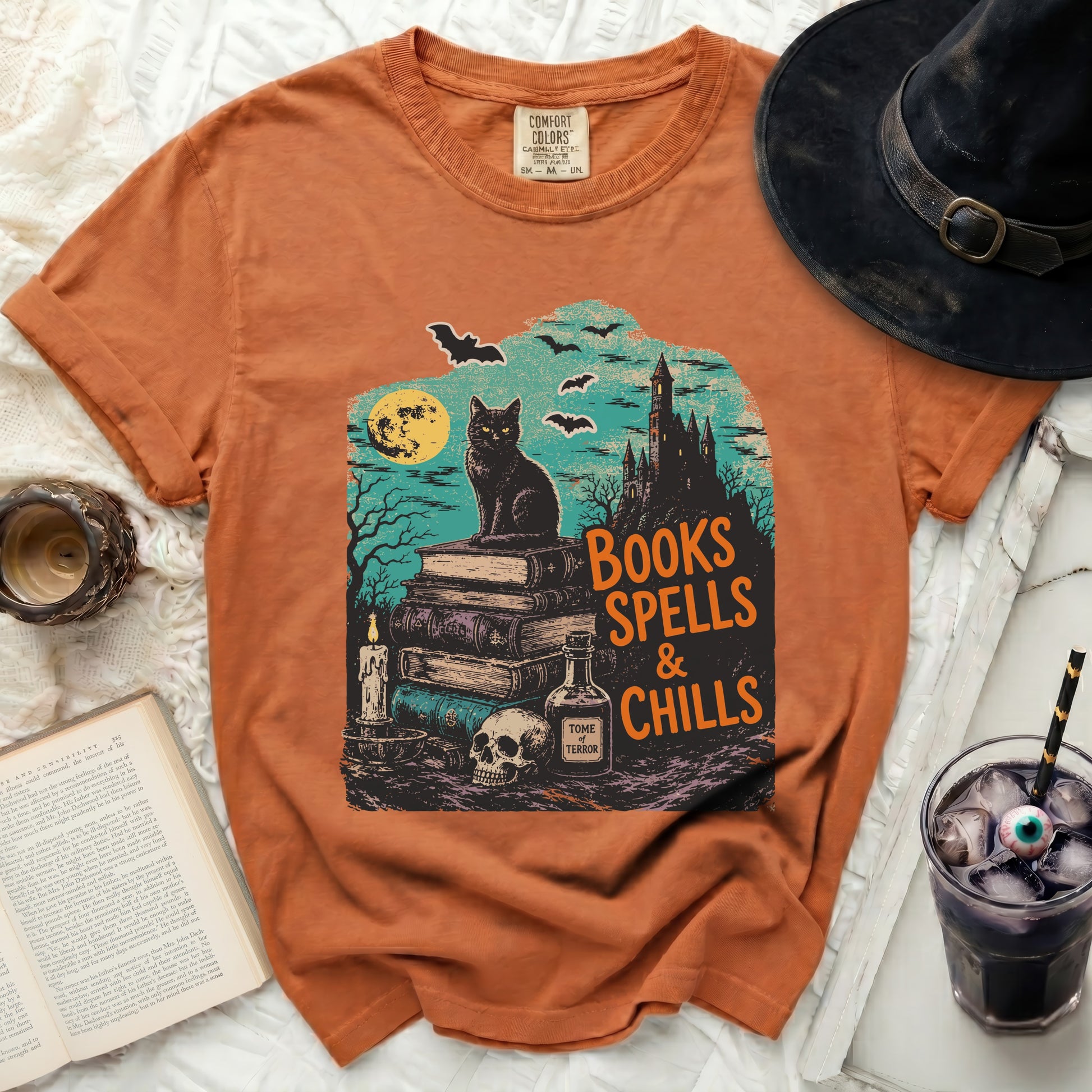 Orange t-shirt with a vintage Halloween graphic of a black cat and castle.