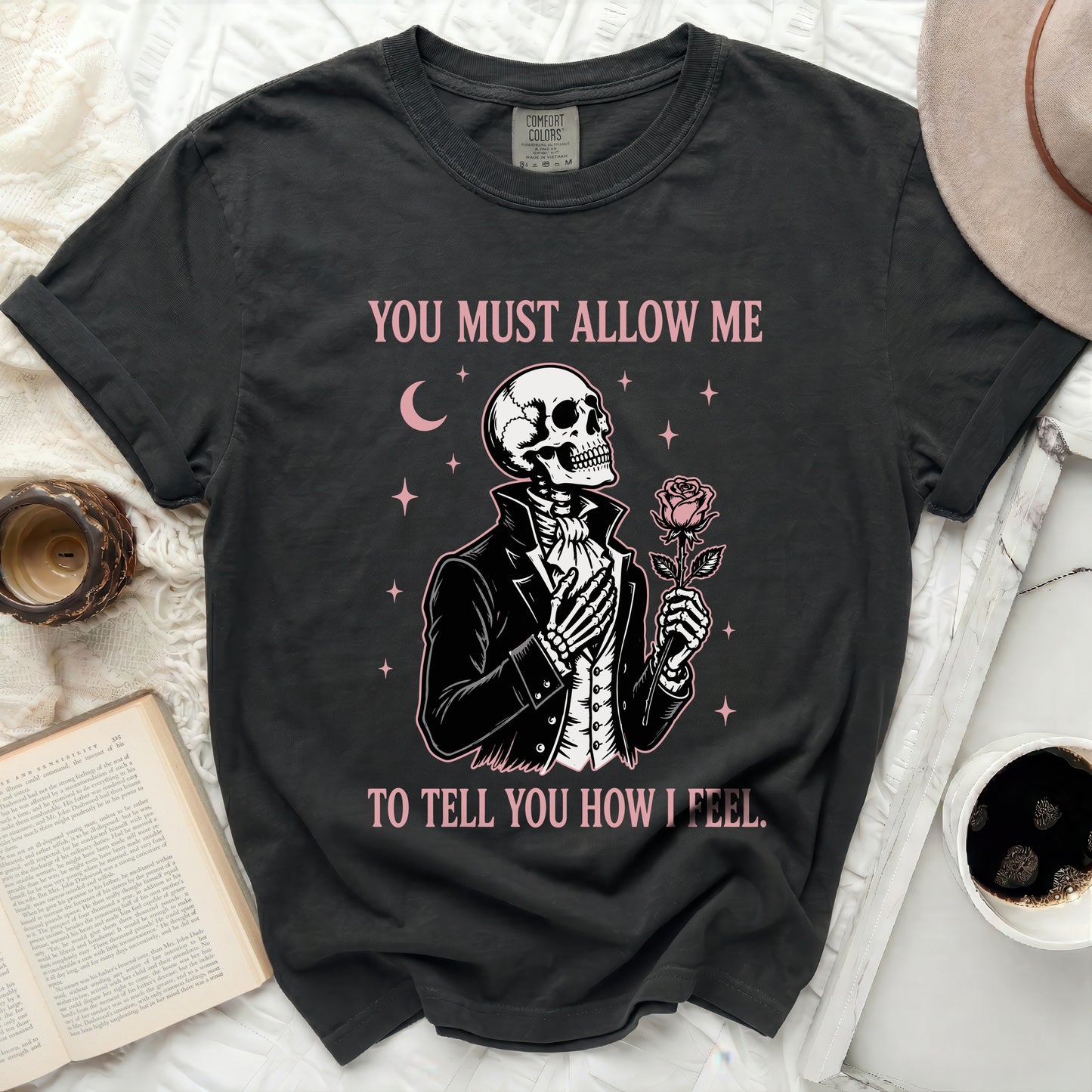 Black t-shirt with a skeleton graphic holding a rose and text.