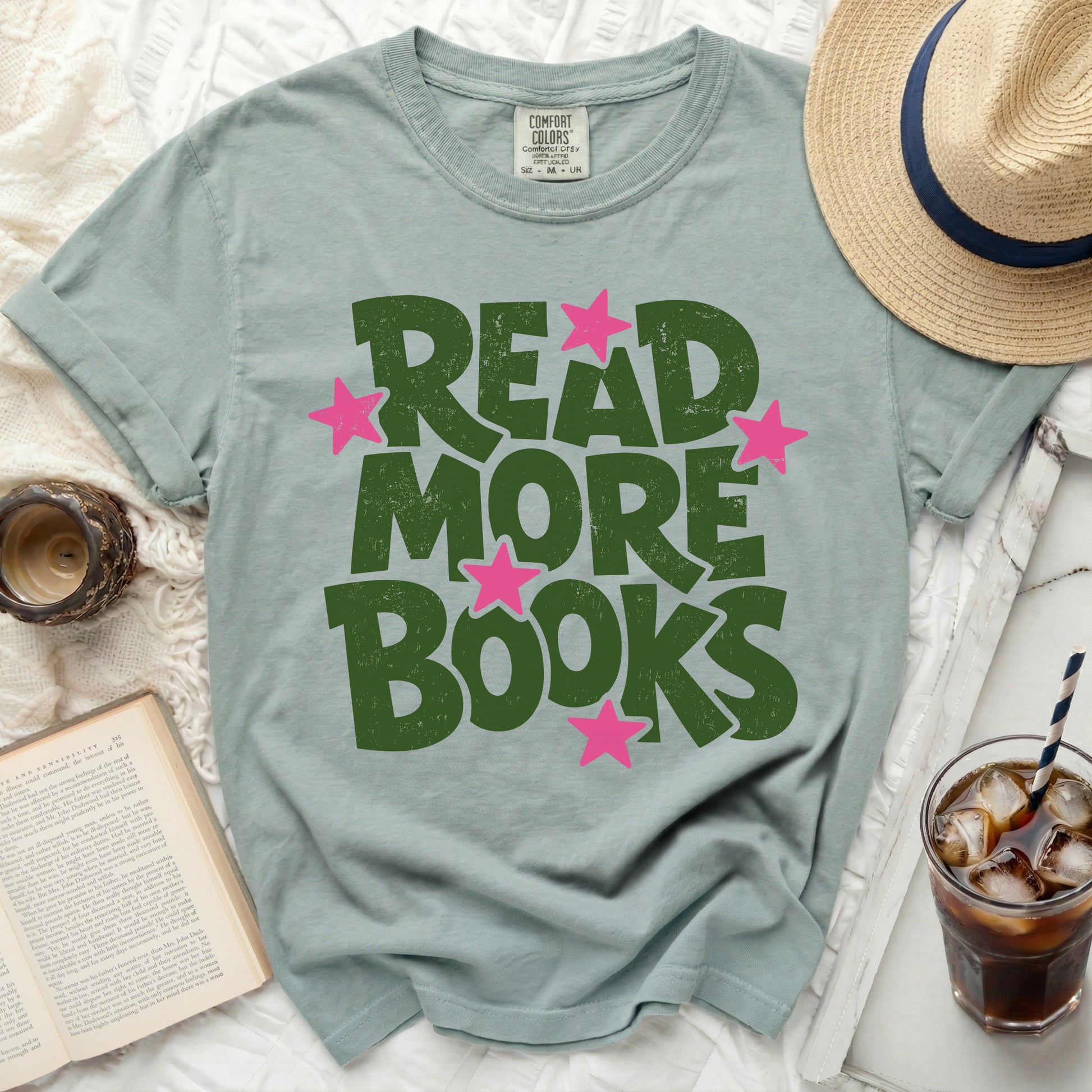 Green t-shirt with "READ MORE BOOKS" graphic and pink stars.
