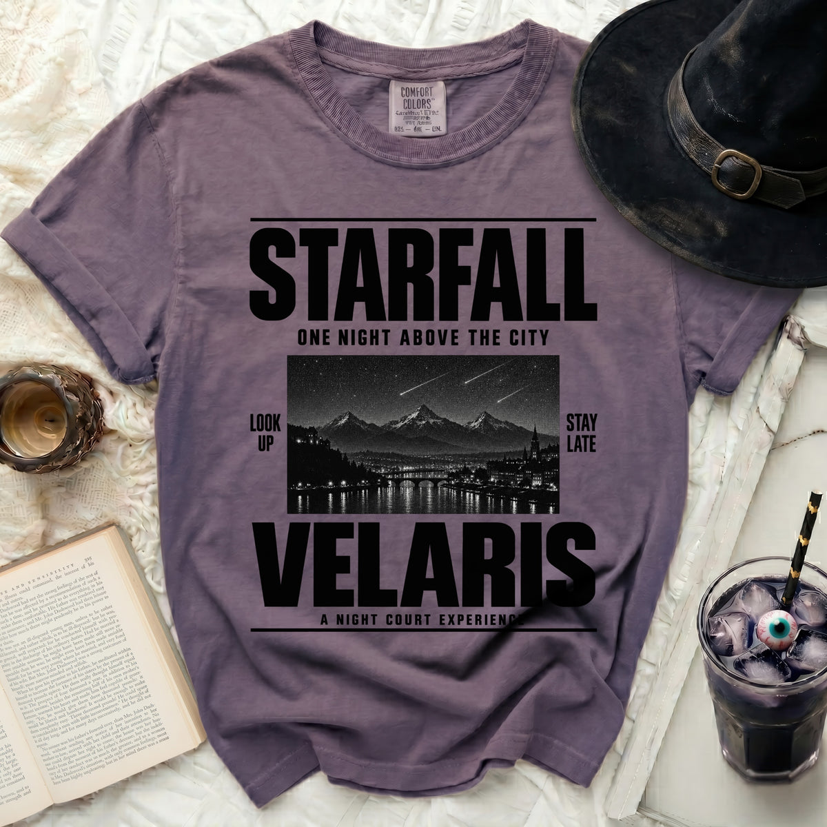 Purple t-shirt with "Starfall Velaris" text and night city skyline graphic.