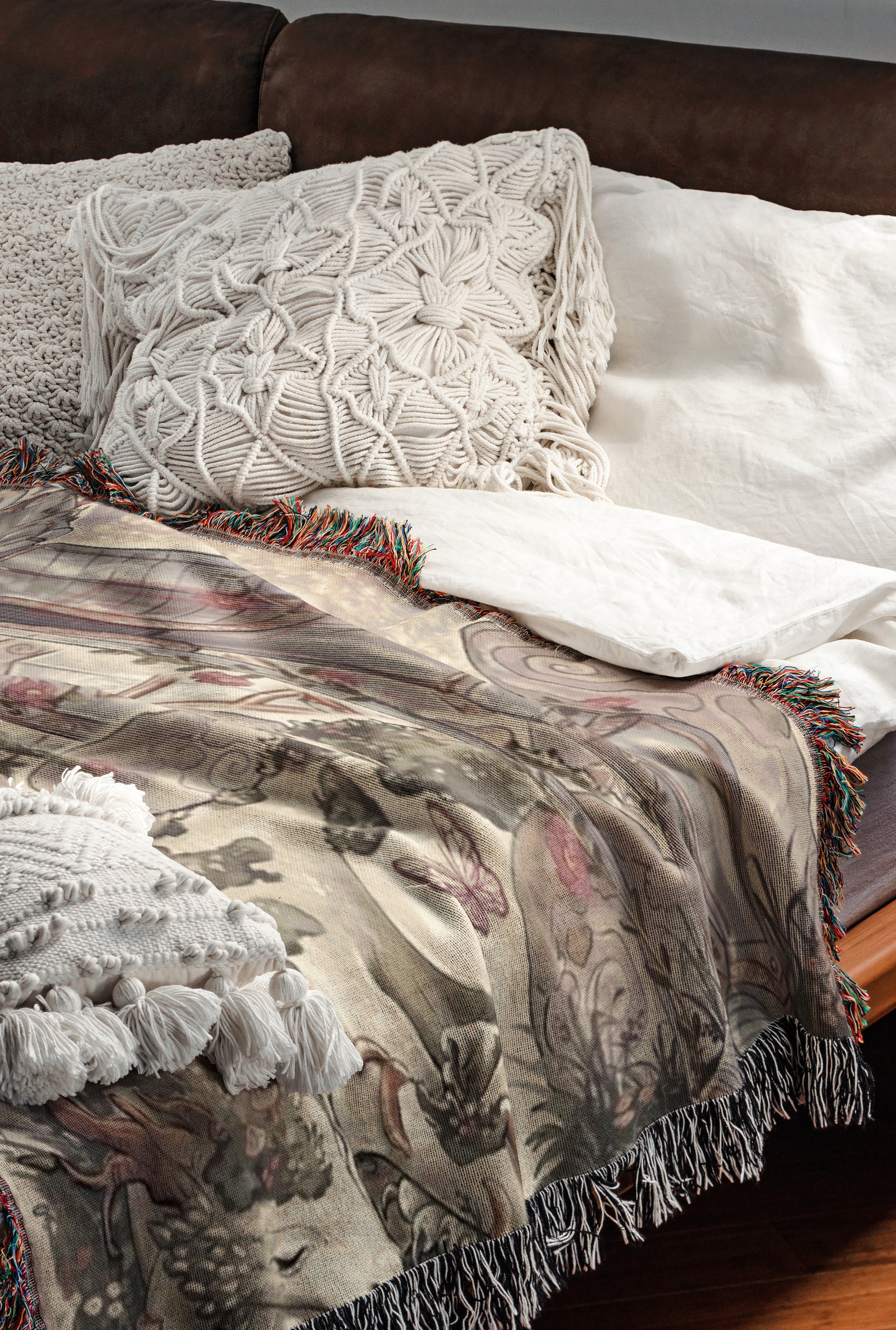 a cozy and inviting bedroom scene, featuring a bed with a white comforter and a decorative throw blanket with a floral pattern. The bed is adorned with two white pillows and a single throw blanket with fringe details. The overall scene conveys a sense of comfort and warmth, with the bed and bedding items creating a visually appealing and inviting atmosphere.