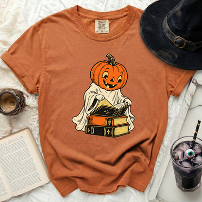 Orange t-shirt with a cartoon pumpkin ghost reading books.