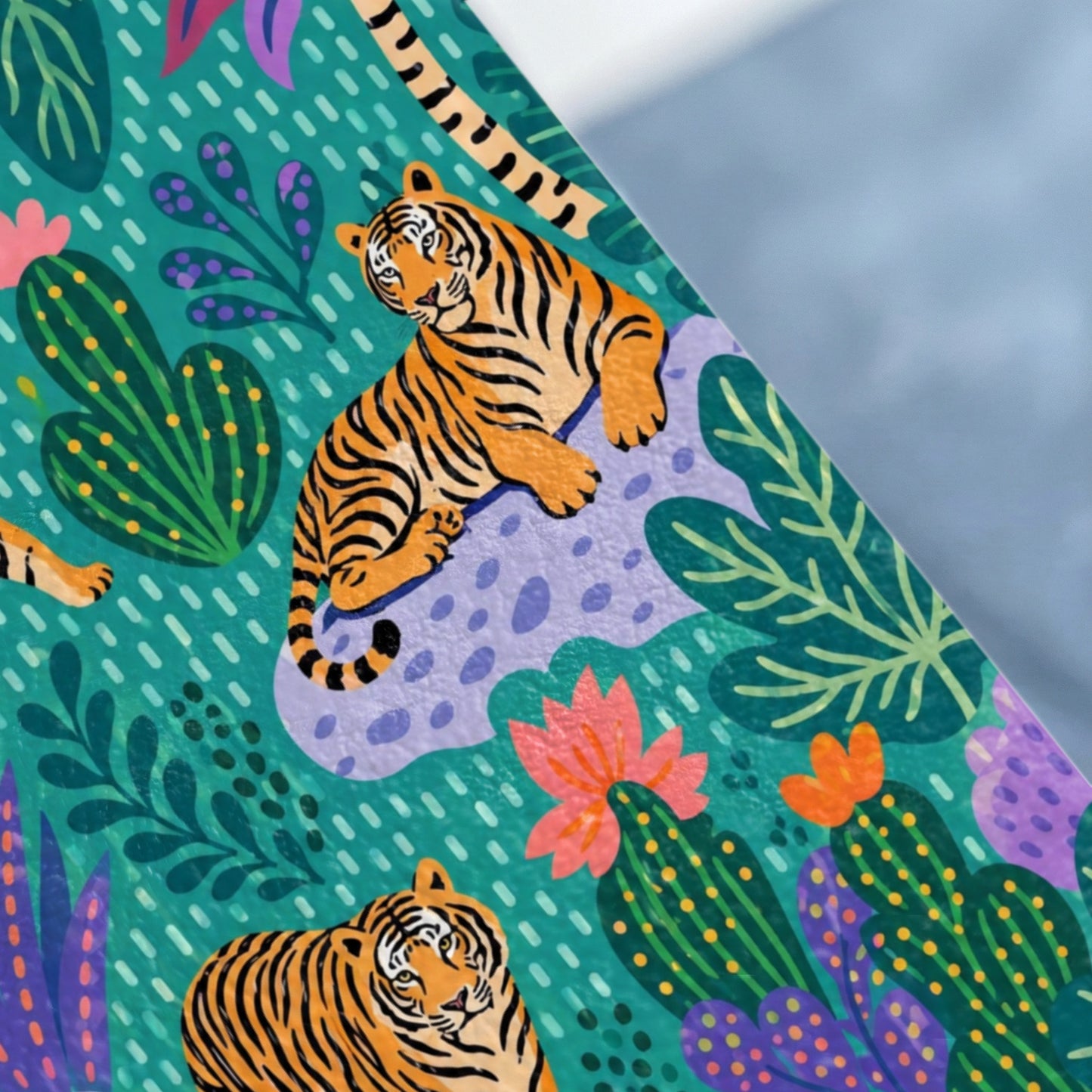 Pattern of tigers and colorful plants on a teal background with gray diagonal overlay.
