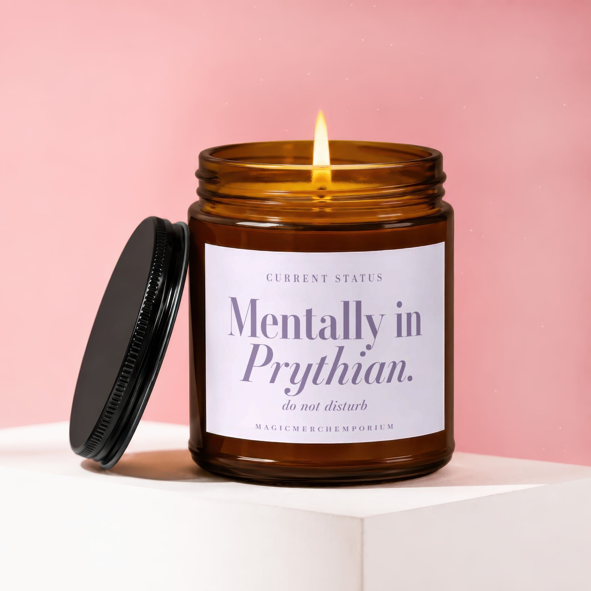 Amber jar candle with lit flame showing label "Mentally in Prythian. do not disturb."
