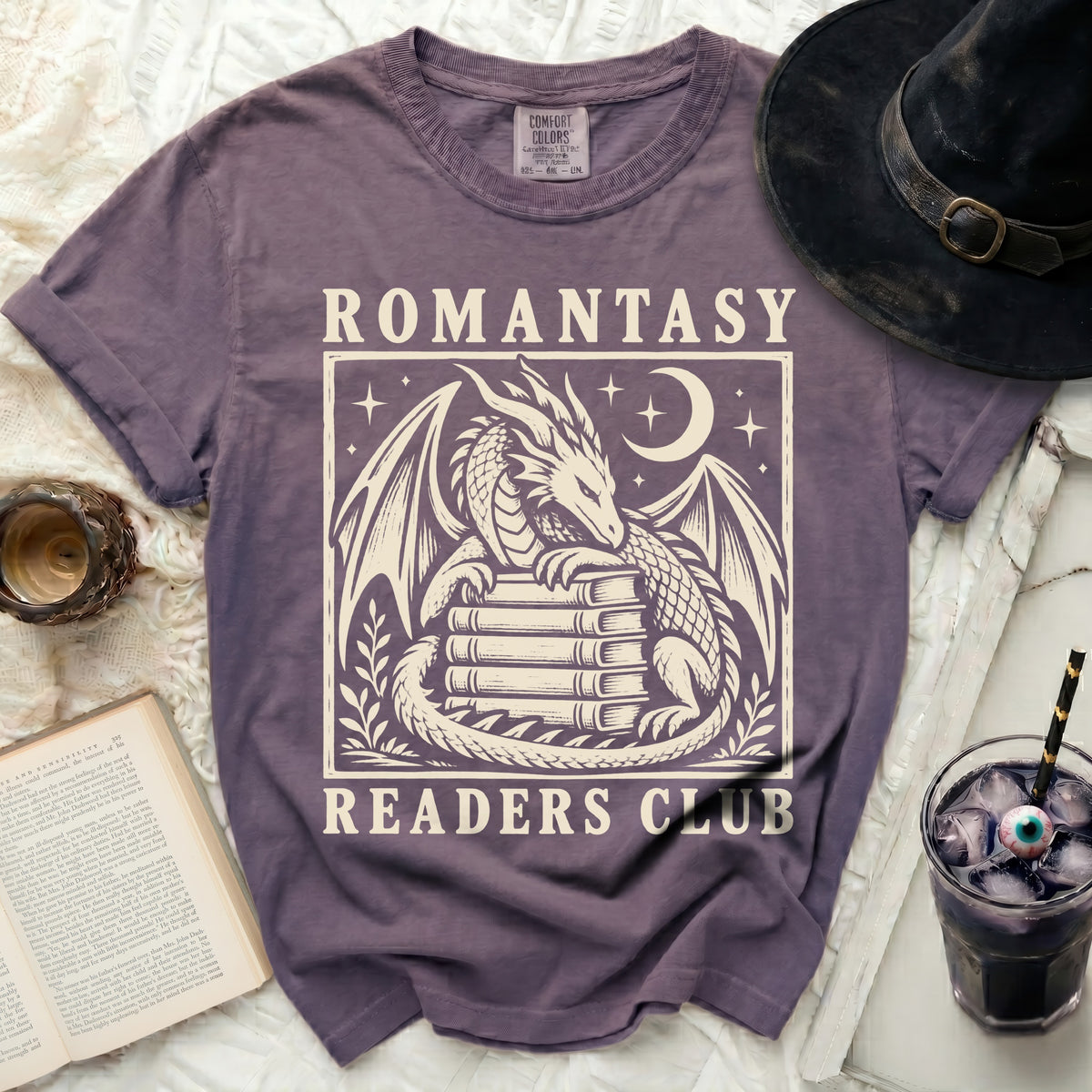 Purple t-shirt with a dragon on books design and "Romantasy Readers Club" text.