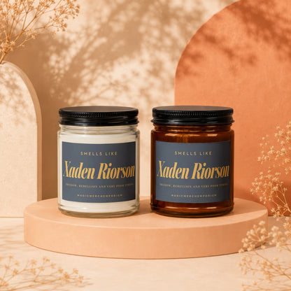 Two "Xaden Riorson" candles, one clear, one amber, with labels.