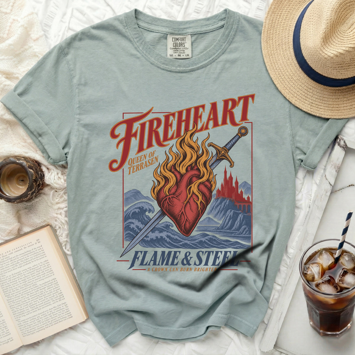 Light blue t-shirt with "Fireheart," "Queen of Terrasen," and "Flame & Steel" graphic.
