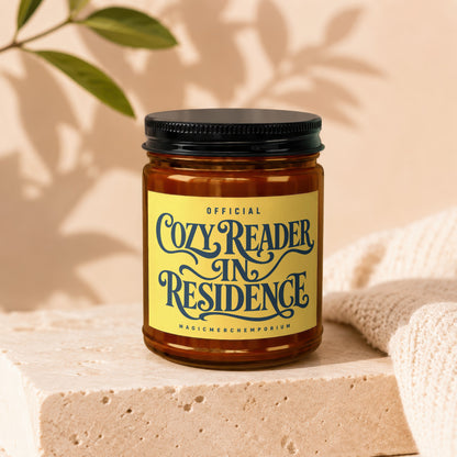 Cozy Reader in Residence candle with decorative label.