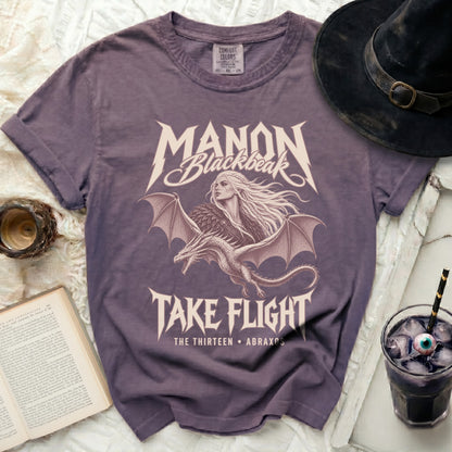 Purple t-shirt with "Manon Blackbeak Take Flight" design and dragon.