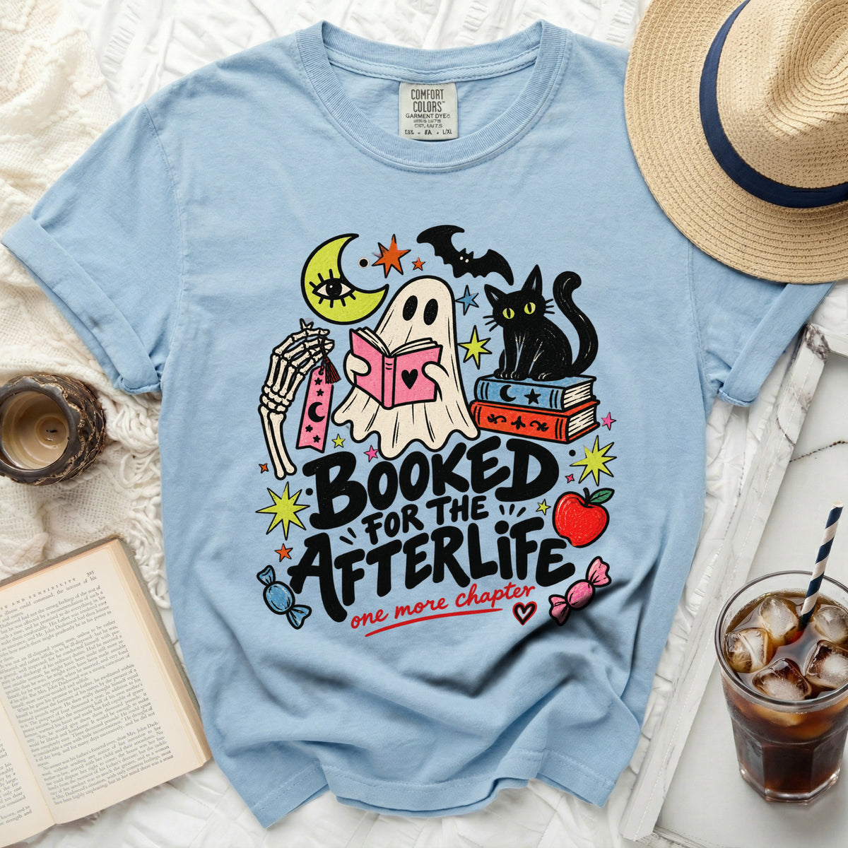 Light blue t-shirt with "Booked for the Afterlife" graphic featuring ghost and cat.