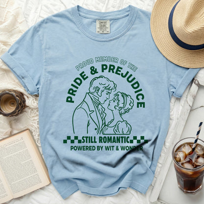 Light blue t-shirt with "Pride & Prejudice Still Romantic Powered by Wit & Wonder" graphic.