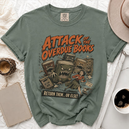 T-shirt graphic: "Attack of the Overdue Books" with monstrous books chasing a woman.