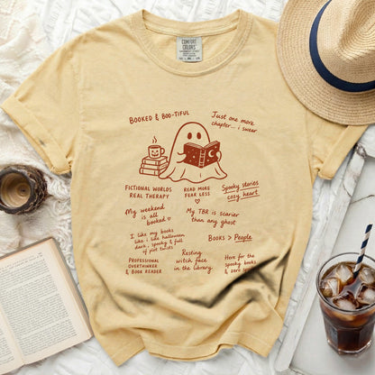 Yellow t-shirt with ghost reading books and book-themed phrases.