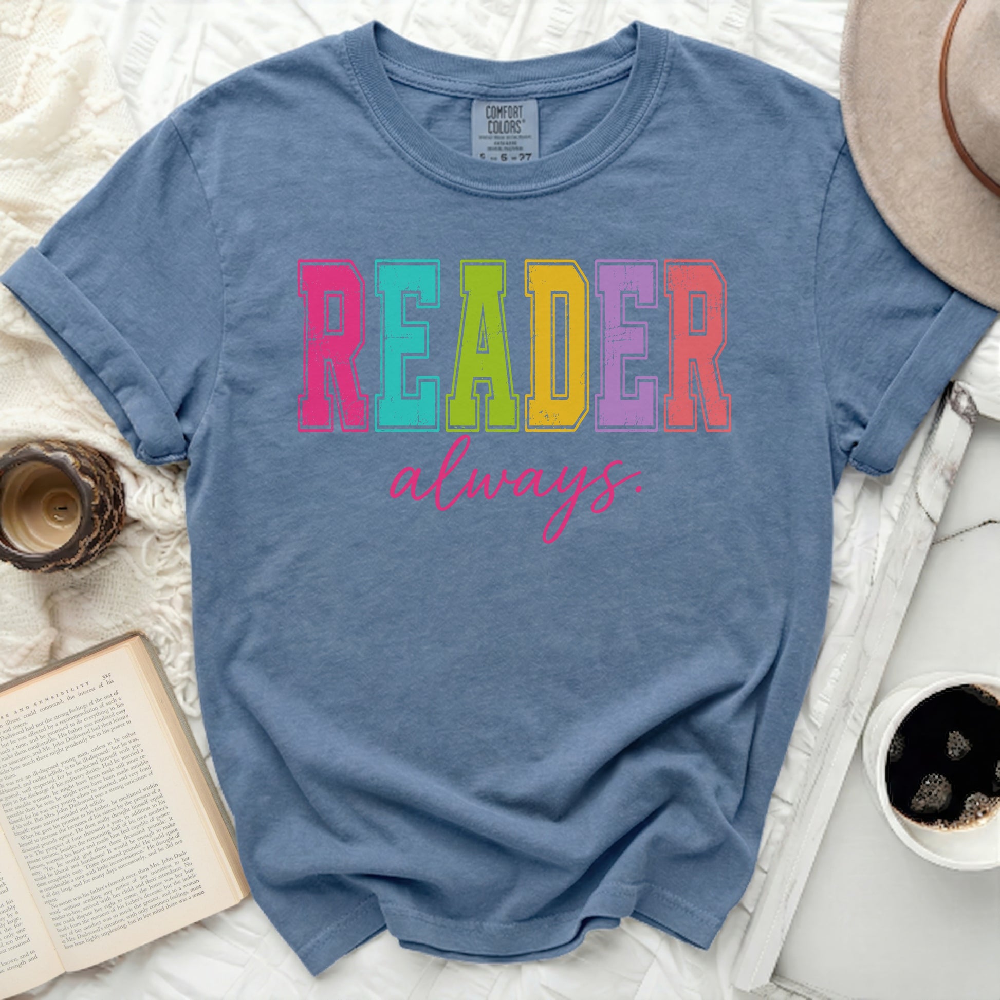 Blue t-shirt with "READER always" in colorful block letters.