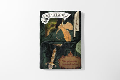 Fluffy dark green blanket with a dragon, sword, and text "The spell could be broken only by love."