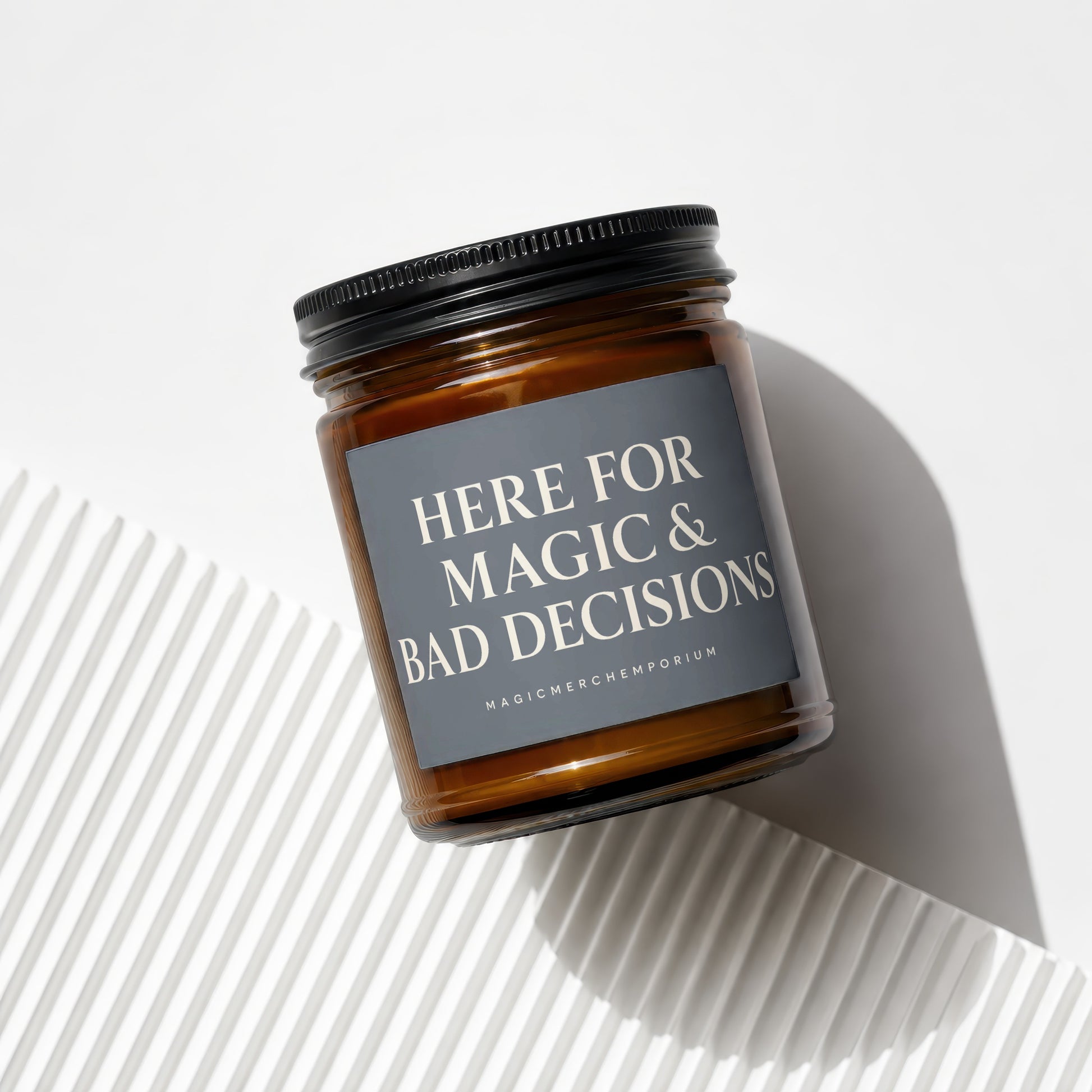 Glass candle jar with black lid, "Here for magic & bad decisions" text.