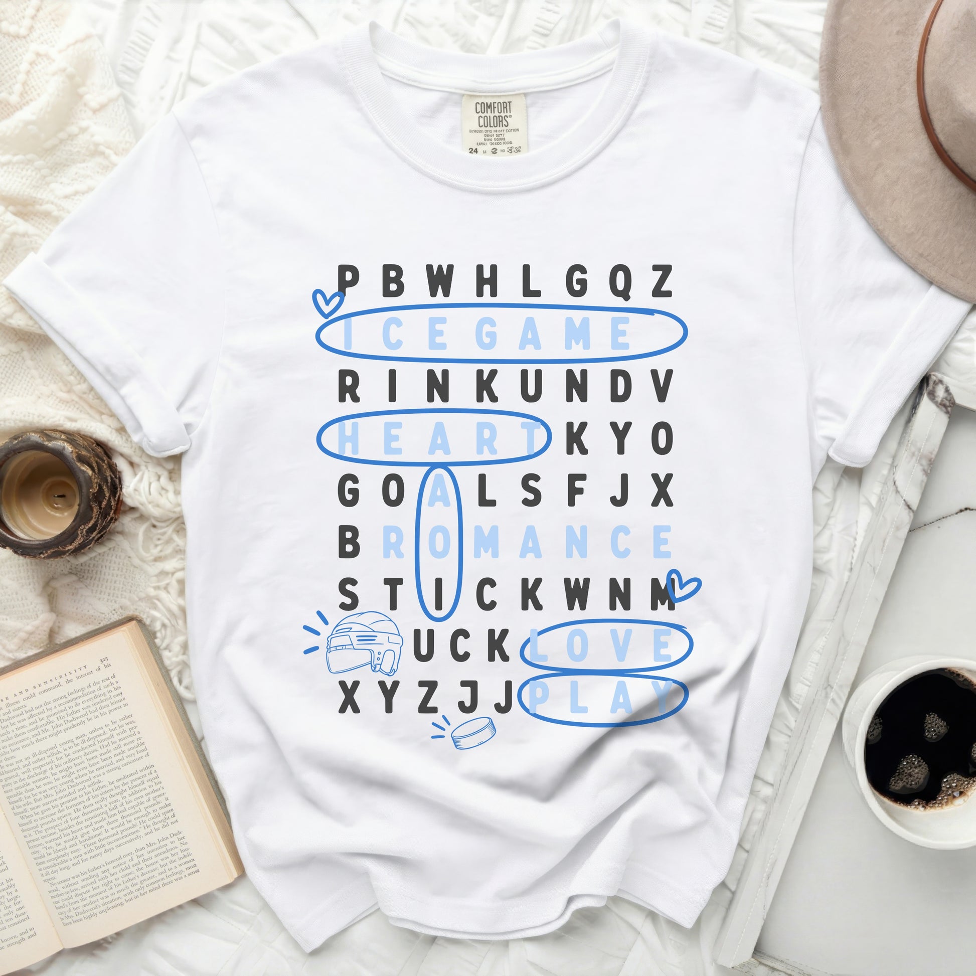 White t-shirt with word search for hockey phrases: puck love, goals, romance.