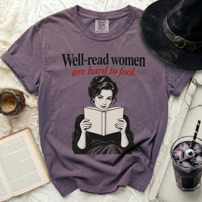 Purple t-shirt with "Well-read women are hard to fool" and vintage woman reading.