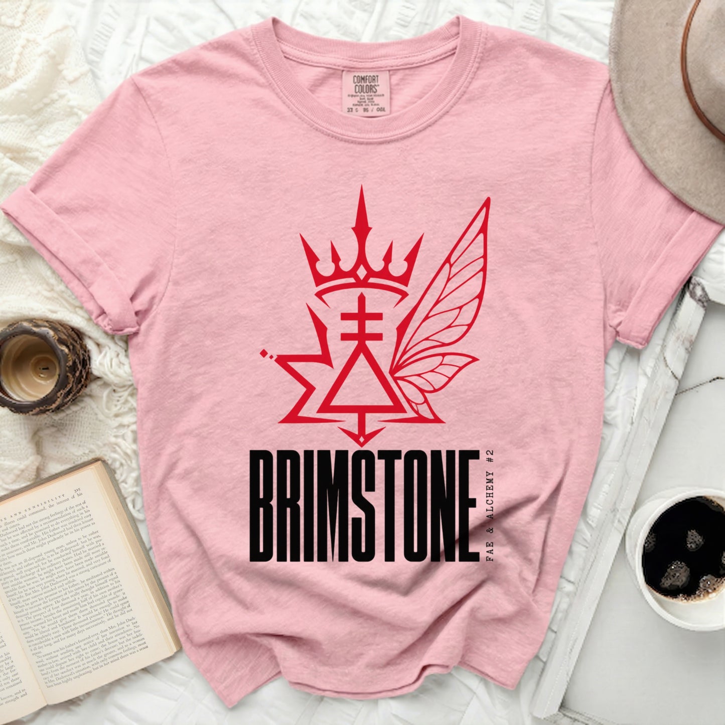 Pink t-shirt with "BRIMSTONE FAE & ALCHEMY #2" graphic.