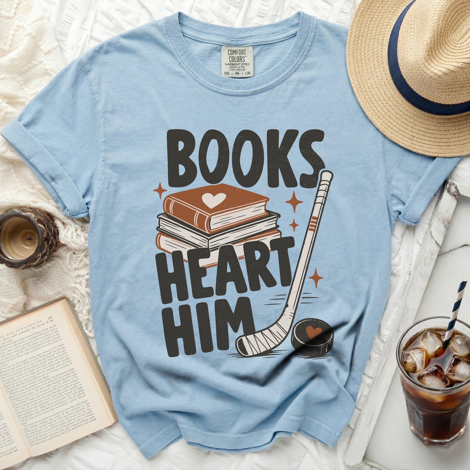 Blue t-shirt with "Books Heart Him" text, book, and hockey puck.
