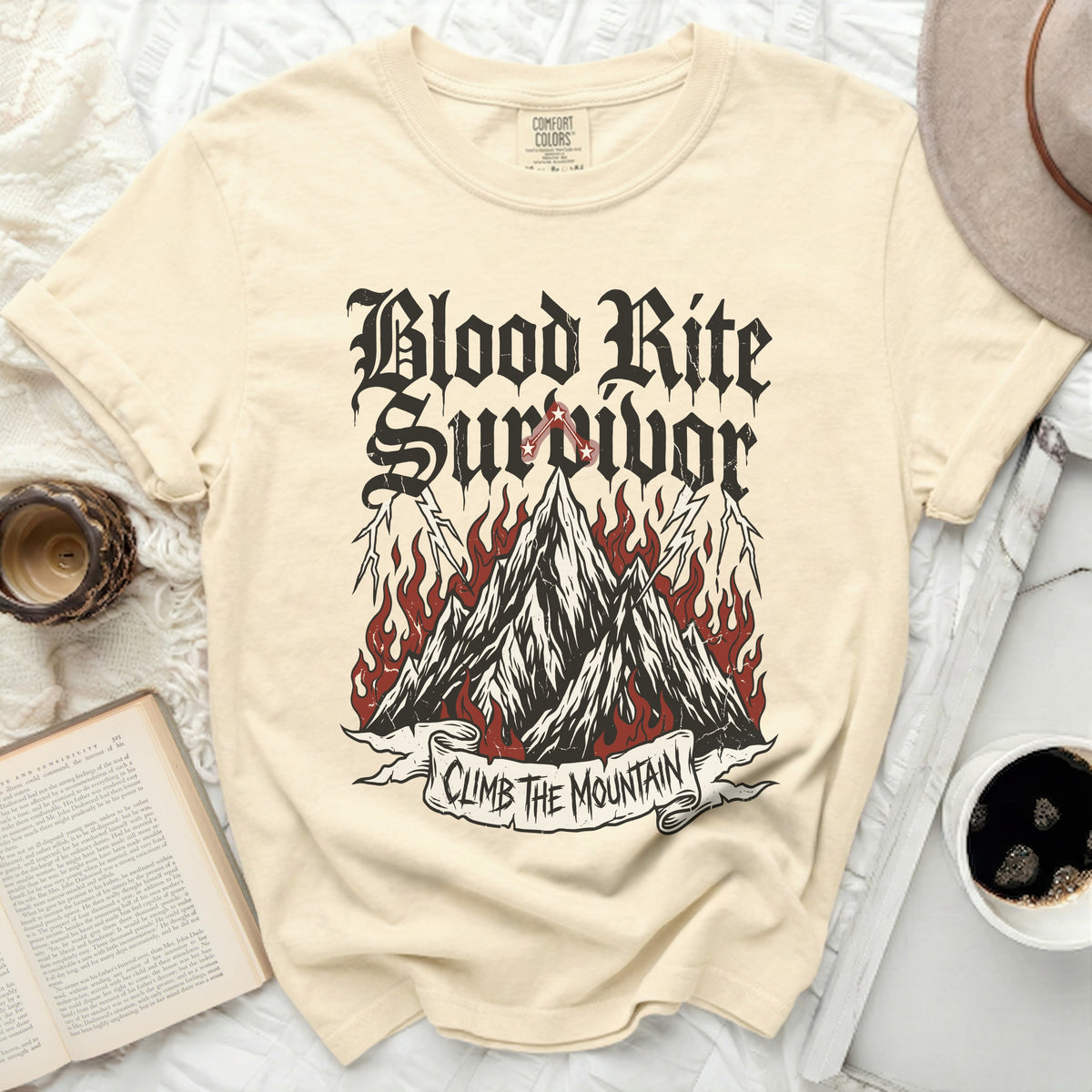 Cream t-shirt with "Blood Rite Survivor Climb The Mountain" graphic.