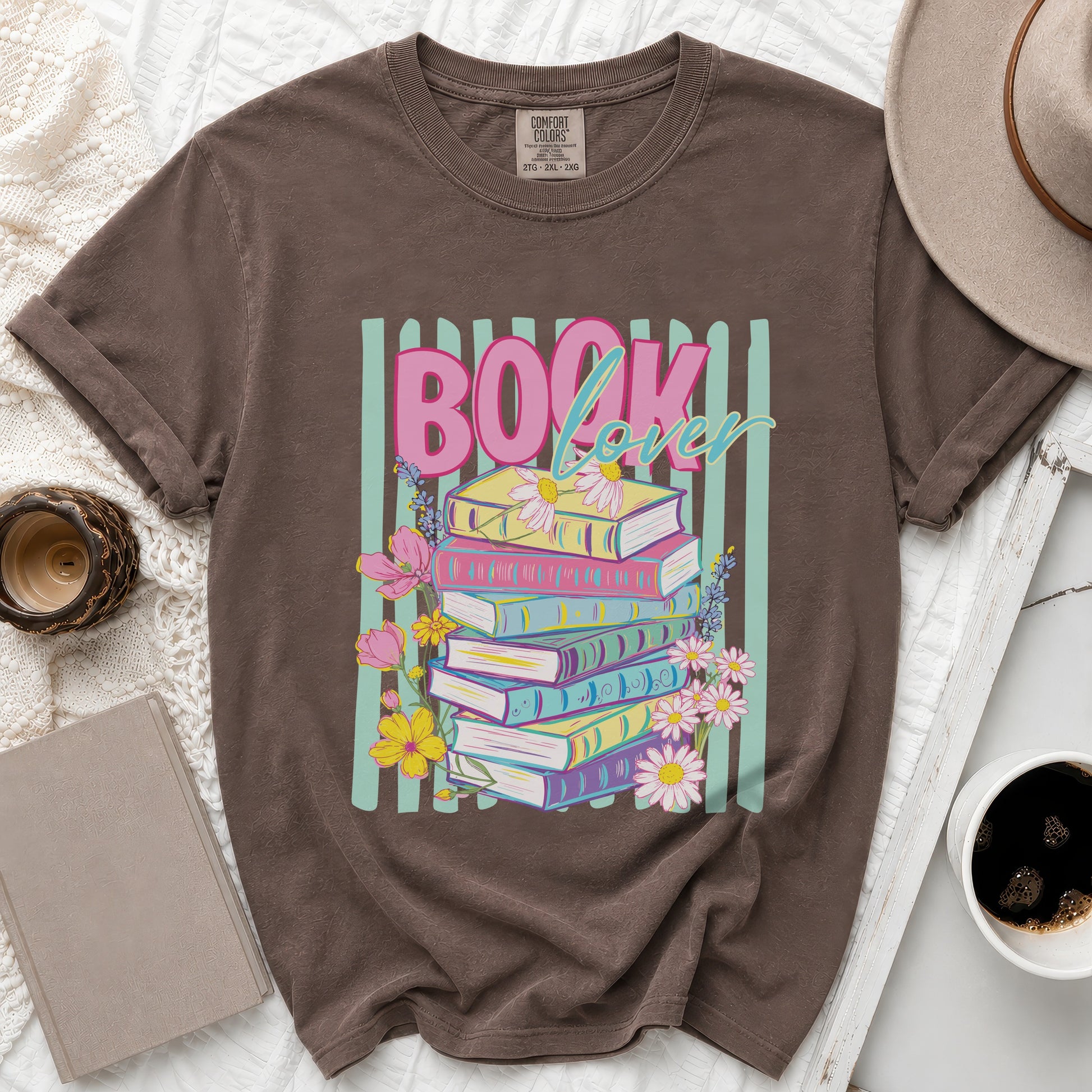 Brown graphic t-shirt with pink "BOOK lover" text and stacked colorful books.