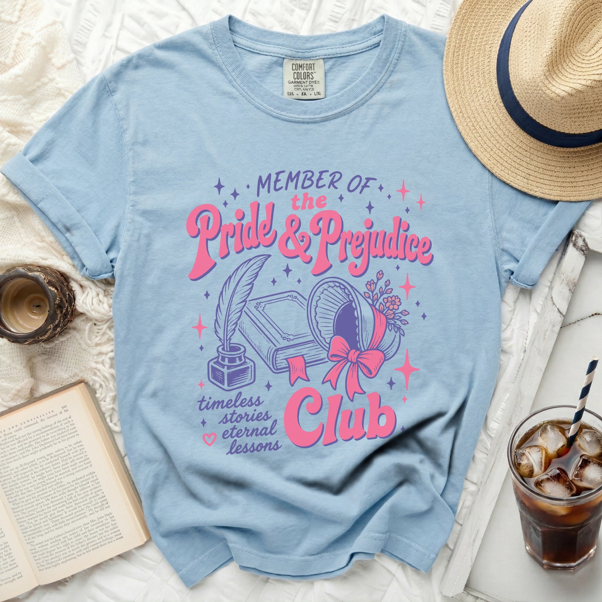 Light blue t-shirt with "Member of the Pride & Prejudice Club" text and book graphics.
