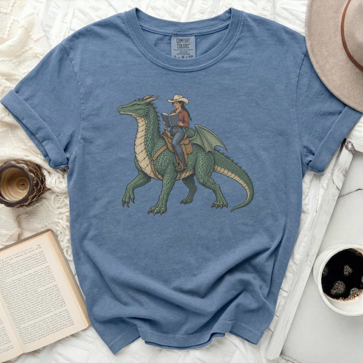 Woman in cowboy hat riding a dragon and reading a book.