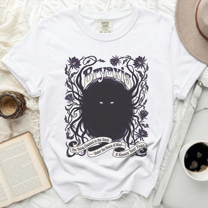 White t-shirt with Bryaxis graphic and quote "The Thing Chained in the Dark".