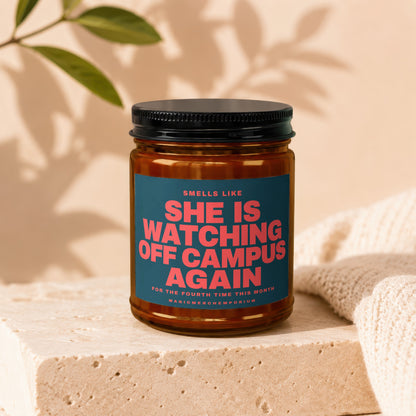 Candle with text "Smells like she is watching off campus again".