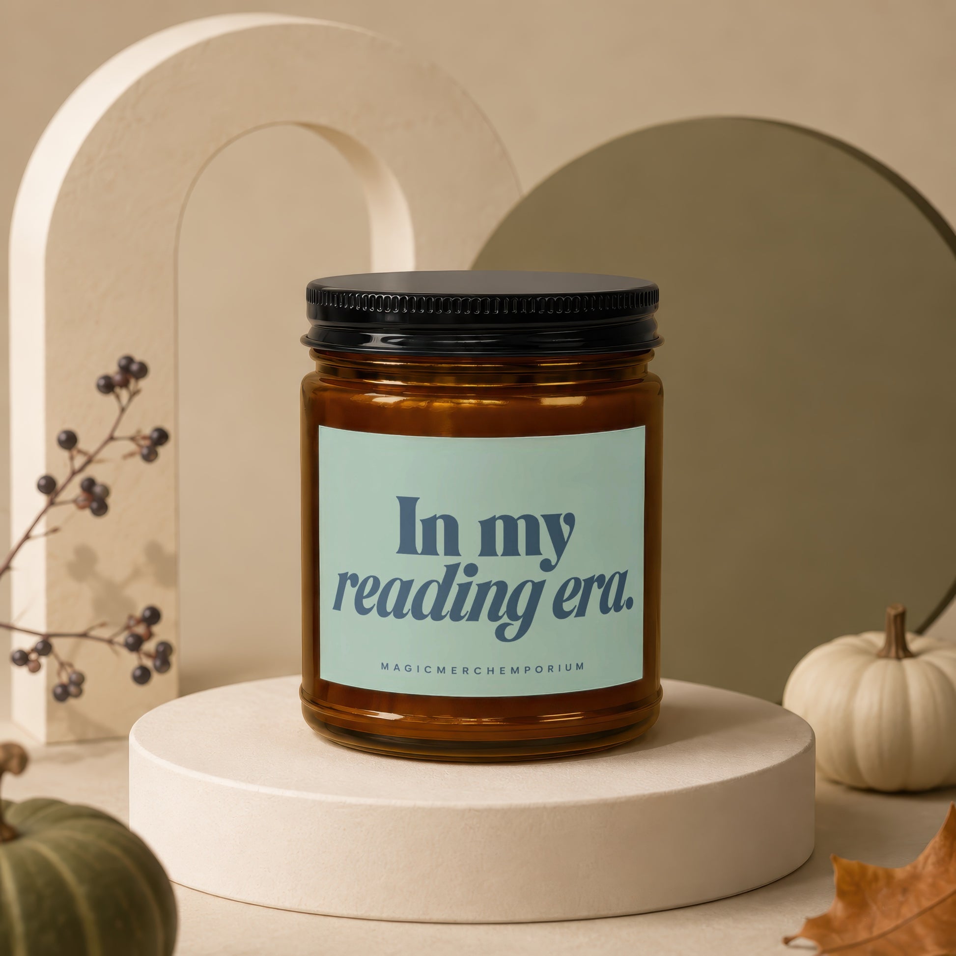 Amber candle with black lid and label reading "In my reading era."