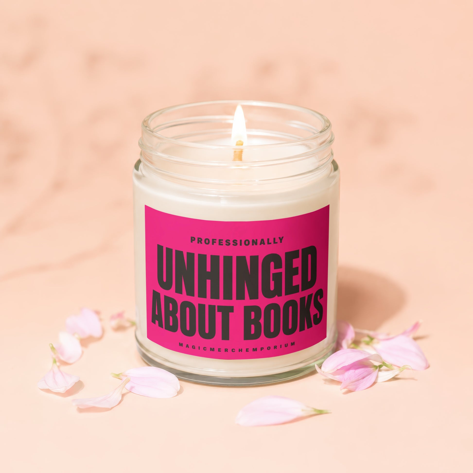 Jar candle with a pink label reading "Professionally Unhinged About Books."